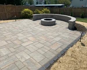 Backyard firepit with a seat wall incorporated into the design